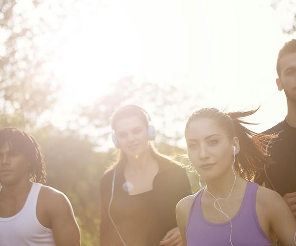 Diverse group of people smiling during a light outdoor activity.